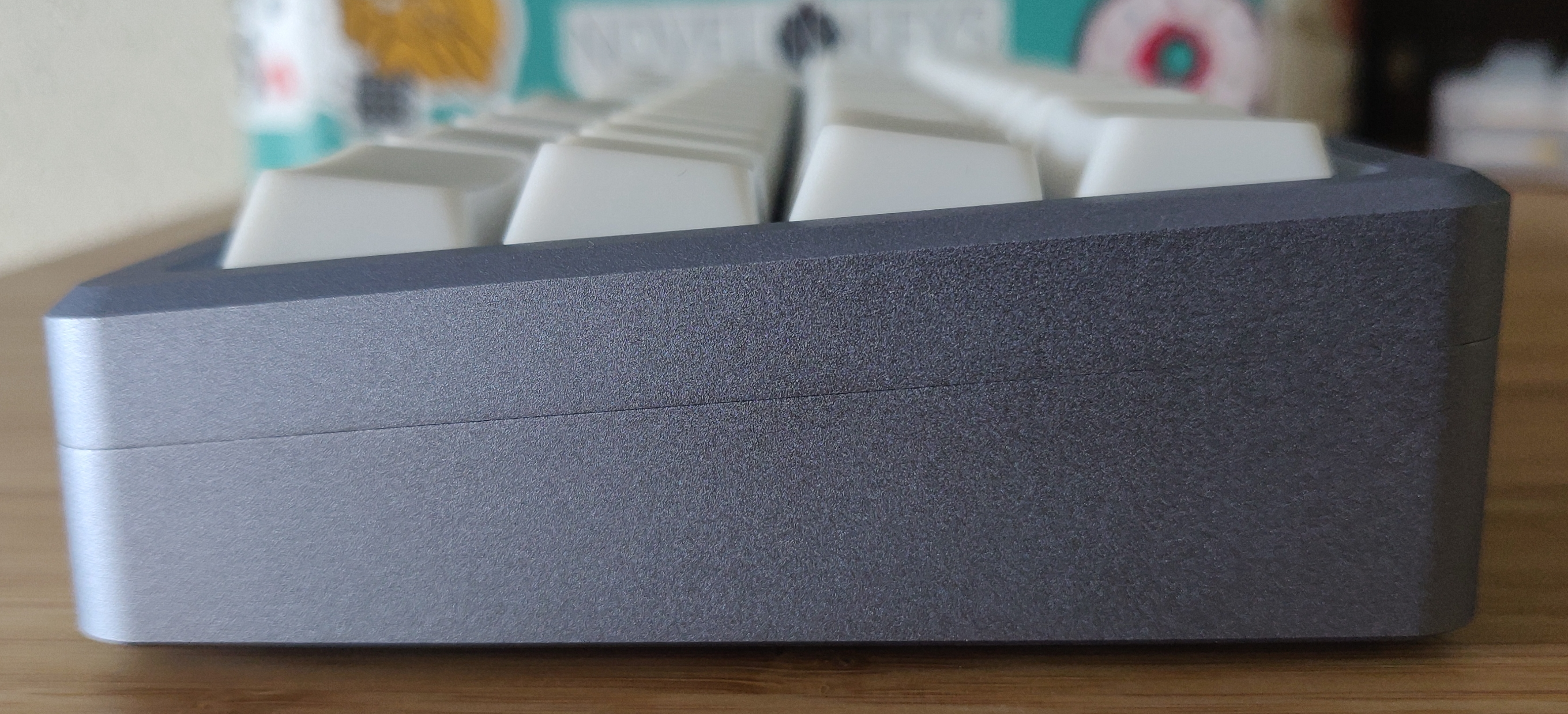 Side view of blank white Cherry profile keycaps in a space grey Campsite