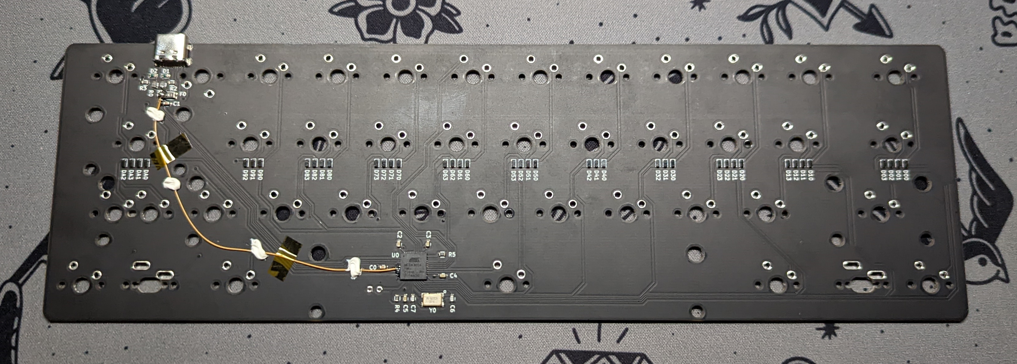 Back of an R1 Goon PCB. The bodge wire was installed by the factory to replace the missing trace.