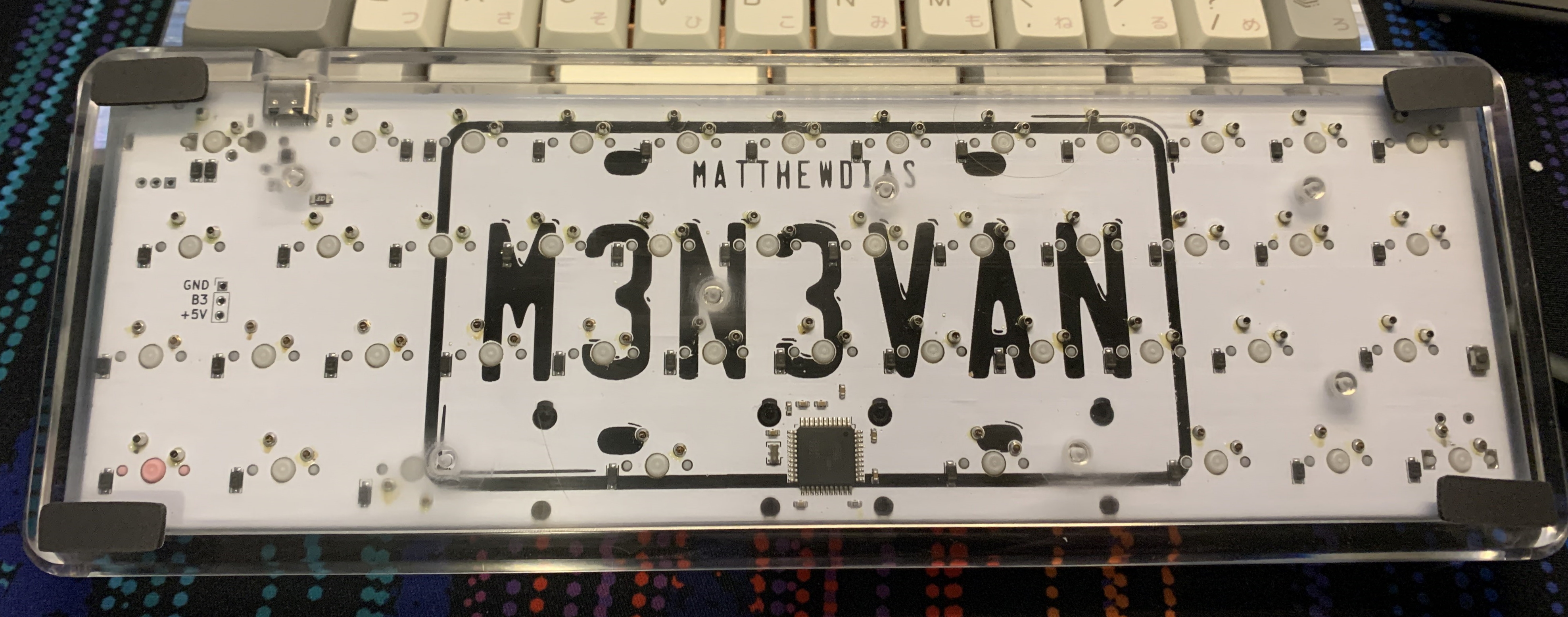 Bottom of a clear acrylic MFR prototype with a m3n3van rev2 PCB