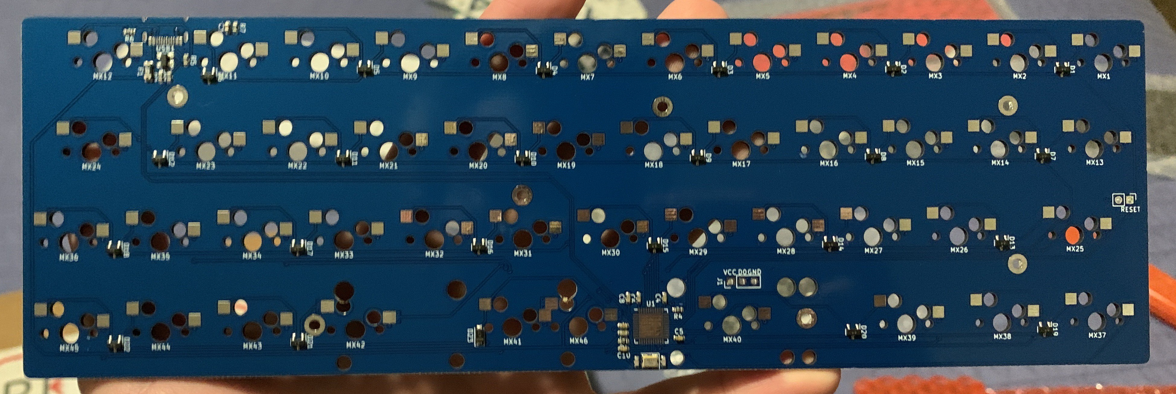 Blurry pic of the back of a partially-assembled PCB