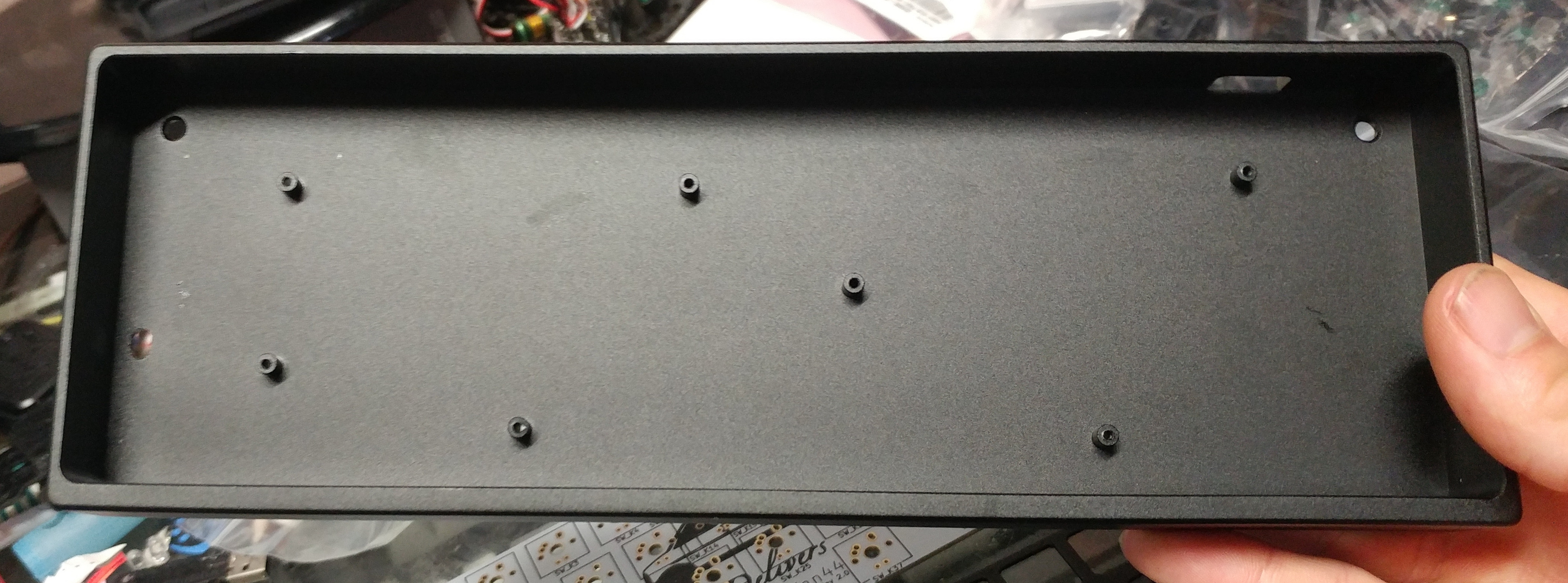 Inside of a black MiniVan R2 case showing the updated mounting hole pattern