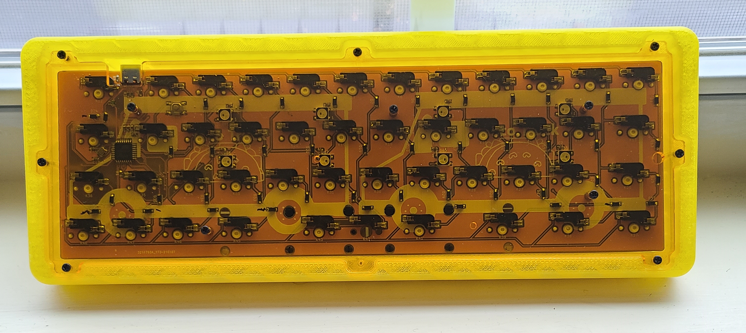 Back of a prototype Taco Truck PCB installed in a case. The offset USB port can be seen in the upper-left corner